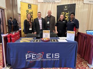 PEO EIS Human Resources personnel stand at the PEO EIS booth at a recent hiring fair